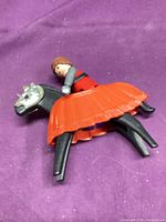 Knight figure on horse with orange barding and silver armor mask