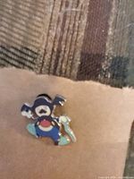 Front view of Pokémon enamel pin showing character design and colors