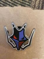 Front view of enamel pin showing design and colors