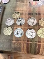 Eight Pokémon coins laid out showing variety of finishes and designs