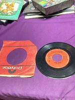 Record alongside torn Polydor sleeve