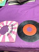 Record in worn sleeve on table
