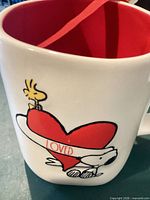Front view of mug showing Snoopy, Woodstock and red heart graphic