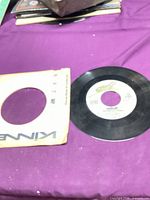 Record with paper sleeve on table