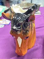 Front view of Relpo ceramic horse head planter showing orange-brown glaze, black mane and cream interior