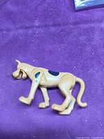 Left side view of Scooby-Doo plastic figure showing articulation and black spot