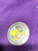 Front of coin showing Koopa Troopa enamel image and star rim