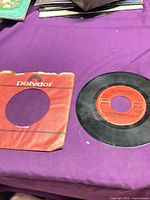 Record and torn red Polydor sleeve