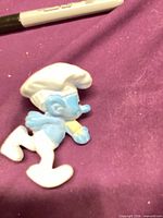 Front angled view of Chef Smurf figure showing pose and baguette