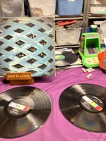 Front of gatefold sleeve beside both LPs