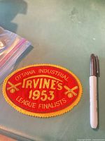 front of oval felt patch with embroidered text