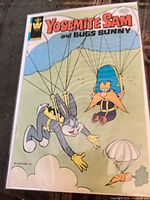 Front cover of Yosemite Sam and Bugs Bunny comic bagged and boarded