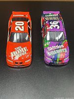 Top view of both die-cast cars showing liveries and numbers