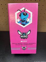Front of pink box featuring Hugo the Hornet image and branding