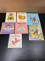 All seven books laid out front covers visible