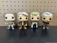 Front view of all four figures standing side by side