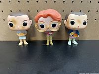 Front view of all three Funko Pop figures standing side by side