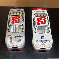 Top view of both cars showing silver and white liveries, number 29 roofs