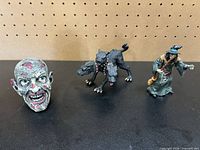 Group shot showing zombie head, three-headed dog, witch figurines