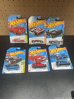 Group shot of all six carded Hot Wheels cars