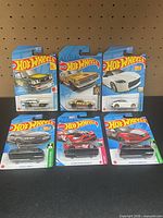 Group shot of all six factory-sealed Hot Wheels cars on cards