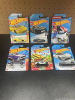 All six sealed Hot Wheels cars on display