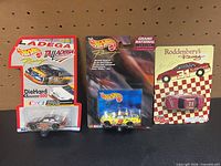 All three carded die-cast cars displayed together