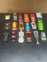 All 18 toy cars arranged in three rows on tabletop