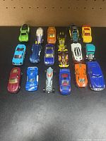 All 18 Hot Wheels cars arranged in three rows