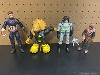 Front view of all four action figures standing side by side