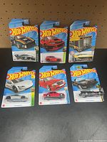 All six sealed Hot Wheels cars displayed front facing