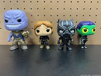 All four loose Funko Pop figures side by side