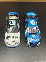 Top view of both diecast cars showing sponsor graphics