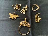 All visible charms laid out on black cloth