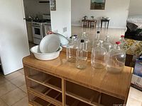 overall view of enamel basins and glass jugs on dresser
