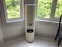 Full view of ivory floor water cooler by windows