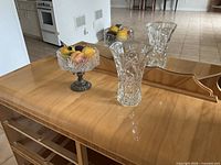 Compote, vase and faux fruit on surface