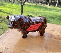 Brown Highland bull ceramic whisky decanter side profile with red Rutherford’s label