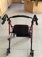 Front view of Drive rollator showing seat, handlebar, brakes, wheels