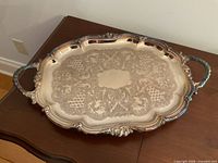 Full view of silver-plated tray showing overall shape, handles and border detail