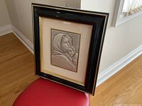 Full view of framed Madonna and Child metal relief artwork