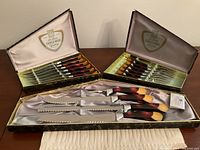 Full view of both presentation boxes open showing knives, forks, carving set