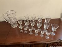 Full set: pitcher and 16 stemware glasses on sideboard