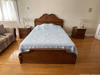 Full view of assembled queen bed showing solid wood headboard, footboard and included bedspread