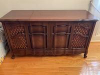 Front view of entire console showing cabinet doors and speaker grills