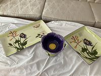 Full view of all three pieces: rectangular platter, square platter, purple pedestal bowl