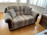 Full view of loveseat showing size, style and wood trim