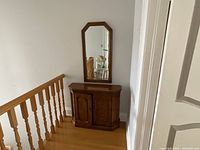console cabinet with wall mirror mounted above