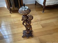 Full view of cherub smoking stand showing overall design and height