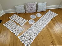 entire set laid out: runner, two mats, three doilies, three pillow covers